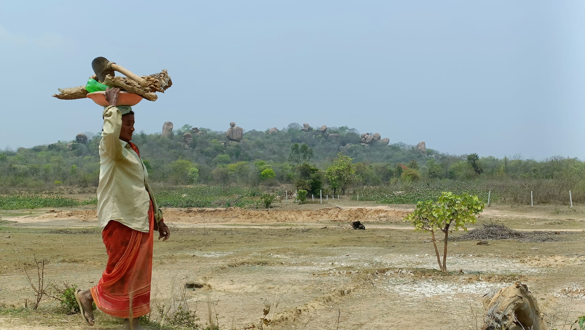Community member walking through natural landscape